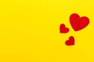 Felt hearts on color background, top view