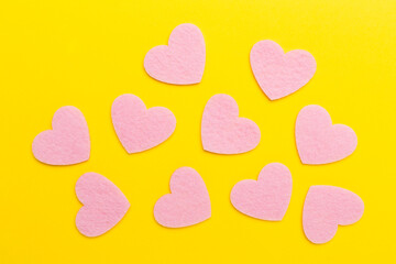 Felt hearts on color background, top view