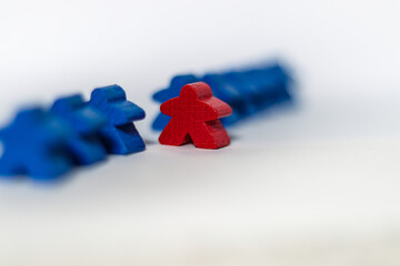 Board game red and blue meeples on the white background concept be individual 