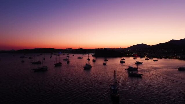 Drone view of boats on the sea at sunset in Bodrum