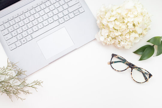 Laptop flat lay with glasses