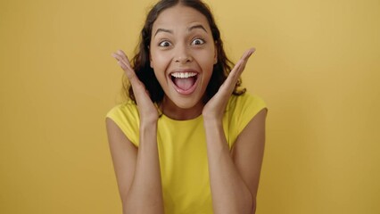 Young african american woman standing with surprise expression over isolated yellow background