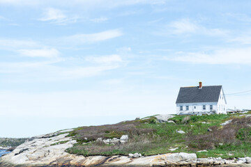 
landscape white house on the hill rocks and grass near sea beach Peggys cove Halifax Nova Scotia, Canada