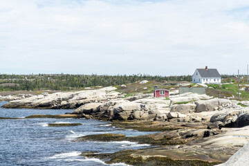 landscape white and red houses on the hill rocks and grass near sea beach Peggys cove Halifax Nova Scotia, Canada