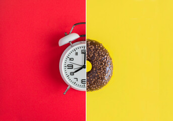 Collage of white alarm clock and donut with chocolate glaze on the red and yellow background. Copy...
