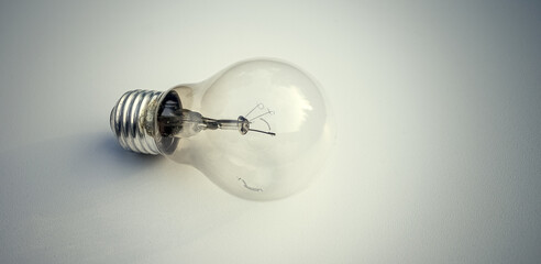 A burnt-out incandescent lamp on a white background. Glass light bulb for lighting.
