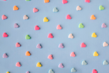 Creative pattern with pastel, pink, blue, yellow, green and other colour hearts. Love flat lay. Minimal valentines day concept.