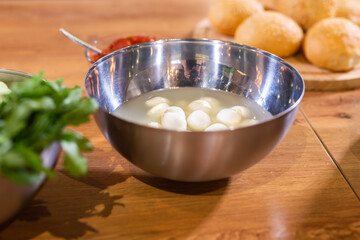 Bowl of small mozzarella balls in kitchen, top view