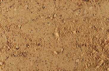 Unrefined brown cane sugar pile background and texture