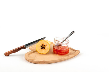 Camera view spoon and knife cutting Fresh ripe quince and jam on white background isolated.