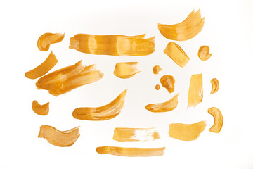 Golden smear. Shiny brush strokes on a white background.