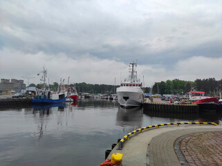 2022-06-02 evening view of the river slupia with promenade and marina in ustka, poland.