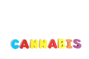 Word cannabis is laid out letters white background.