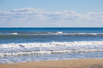Fototapeta na wymiar Striking scene of waves breaking on the sand of a Spanish beach 