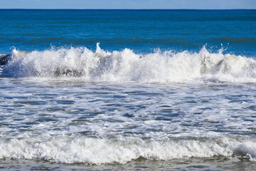 Striking scene of waves breaking on the sand of a Spanish beach	
