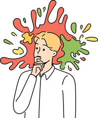 Pensive male employee engaged in creative thinking