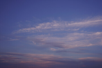 Orange pink purple sunset. Delicate shades. Beautiful evening sky with clouds. Elegant background for design.