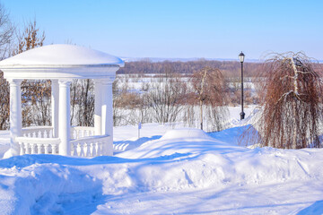gazebo in the snow-covered park of the noble estate