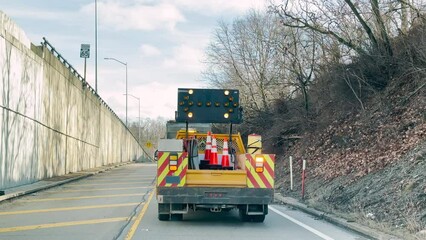 A driver's view stuck behind a construction vehicle repairing a pot hole on a Pennsylvania highway.
