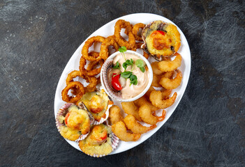 PERUVIAN FOOD. Piqueo caliente. Hot seafood platter fried shrimps, squid rings and baked scallops...