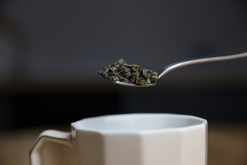 adding green tea to the cup