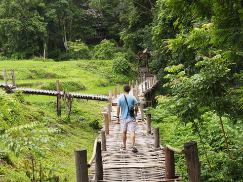 young man in the bamboo bridge of pai thailand