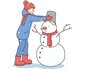 Happy kid build snowman outdoors