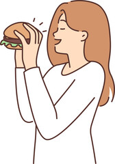 Happy woman eating hamburger