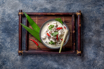 Thai chicken mushroom coconut milk soup TOM KHA GAI in bowl with thai spices. - obrazy, fototapety, plakaty