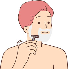 Smiling man shaving with razor