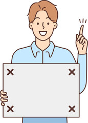 Smiling man with board in hands point up