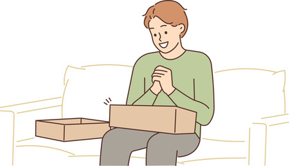 Excited man unpack order at home