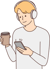 Man in headphones texting on smartphone