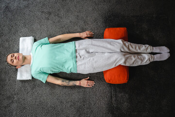 One senior caucasian woman practice restorative yoga at home