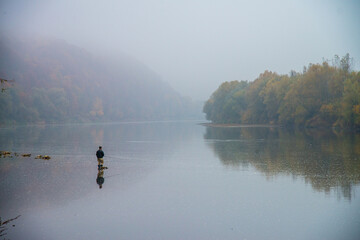 Fishing on the autumn river in the water