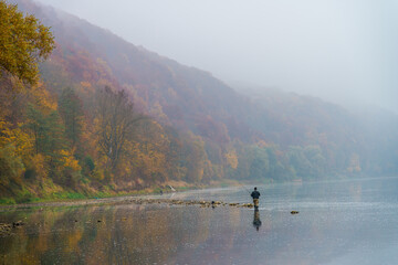 Fishing on the autumn river in the water