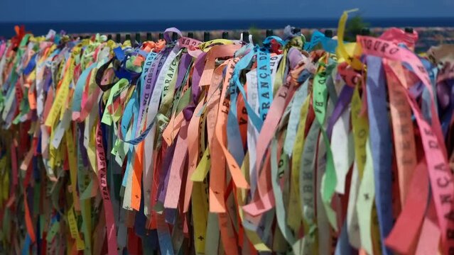 Colored ribbons tied to a fence, souvenir of those who visit Porto Seguro - Bahia, Brazil.