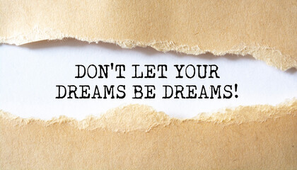 Don't Let Your Dreams Be Dreams. Words written under torn paper. Motivation concept text.