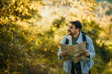 Young hiker man walking through the forest and discovering new places.