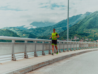 Fototapeta na wymiar An athlete running a marathon and preparing for his competition. Photo of a marathon runner running in an urban environment
