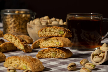 Biscotti Cantuccini Cookie Biscuits with pistachios and lemon peel Shortbread. Cup of tea. Teatime break Healthy eating food. Homemade fresh Italian cookies cantucci stacks and organic pistachios nuts