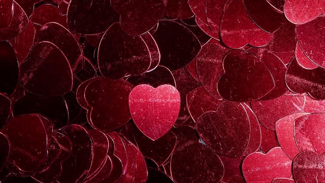 Metallic hearts blow away to reveal a red coloured heart drawn on watercolour textured paper. Love of valentines day theme.