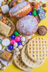 .An assortment of unhealthy foods that are bad for the figure, skin, heart and teeth. Fast carbohydrate food. Space for text