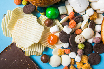 Unhealthy products. food bad for figure, skin, heart and teeth. Assortment of fast carbohydrates food with candy