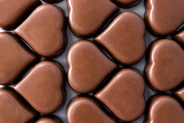 Chocolate candy hearts extremely close-up. Sweet valentine's day concept. Selective soft focus
