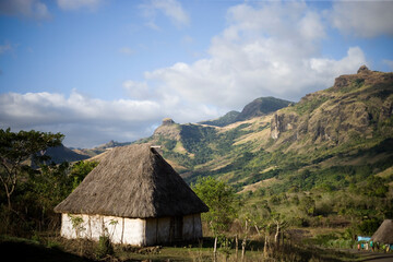 A traditional home overlooks the mountains of Fiji's interior.