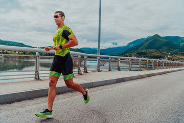 An athlete running a marathon and preparing for his competition. Photo of a marathon runner running in an urban environment