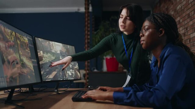 multiethnic women are working together in office of video game development company