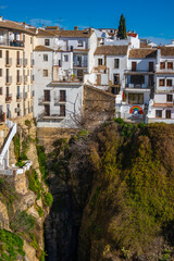 Fototapeta na wymiar Houses built on the edge of the cliff, in the ancient city of Ronda, Spain