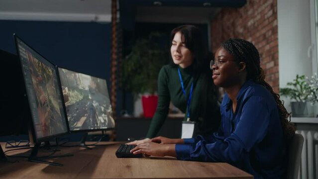 black woman 3D designer and game developer discussion project with supervisor in office